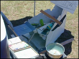 My painting setup with easel, chair and umbrella